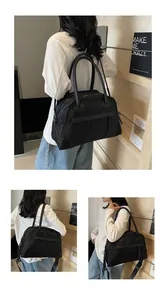 Detail of black nylon travel tote with leather handles and adjustable shoulder strap