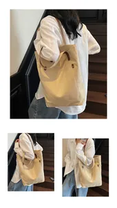 Detail view of large canvas tote bag with front pocket and durable reinforced rivets