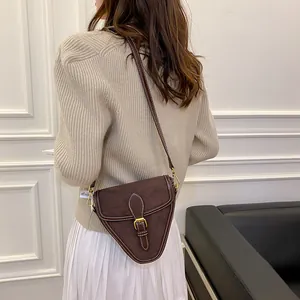 Bolso bandolera triangular de ante marrón oscuro con costuras blancas en contraste