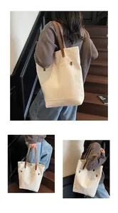 Three-way view of a spacious canvas tote bag with brown leather straps and rivet detail