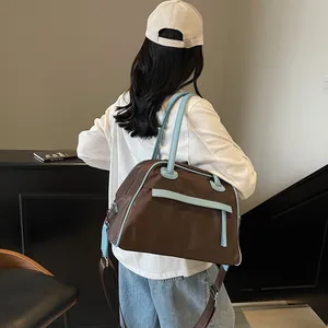 Minimalist large tote bag in dark brown nylon with light blue trim and adjustable straps