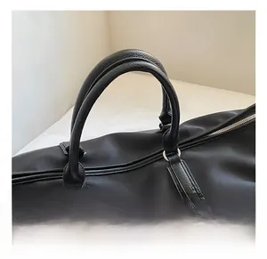 Macro shot of durable black oxford fabric and textured leather handle with metal buckle
