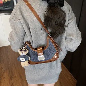 Denim and leather crescent shoulder bag for women with a cute teddy bear charm