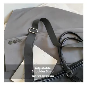 Detail of adjustable black nylon shoulder strap with silver metal buckle on a travel bag