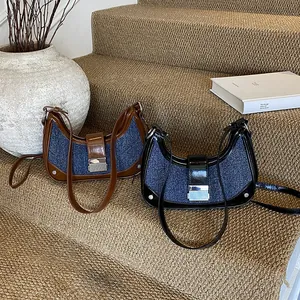 Retro denim and leather patchwork crescent shoulder bag in brown and black colors
