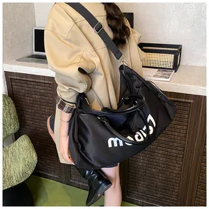 Detailed view of black Oxford travel bag with white mood lettering and adjustable strap