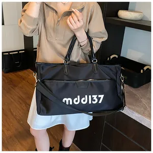 Detail of black large travel bag with mdd137 text and adjustable shoulder strap