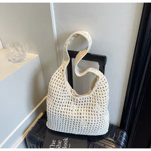 Close-up of beige crochet hollow-out tote bag with cotton cord texture and inner lining