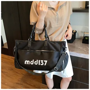 Black Oxford cloth travel bag with white mdd137 print and adjustable shoulder strap