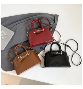 Three leather crossbody bags in burgundy, brown and black with metal ring detail