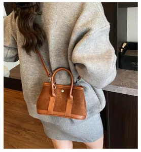 Brown suede tote bag side view showing leather handles and detachable shoulder strap