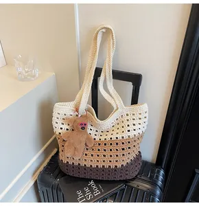 Detail of hollow knit texture on tri-color gradient woven tote bag with bear charm