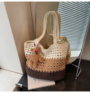 Detail of handmade crochet gradient tote bag with a cute bear charm and woven texture