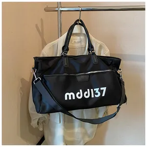 Detail of waterproof nylon travel bag with white mdd137 text and silver zipper