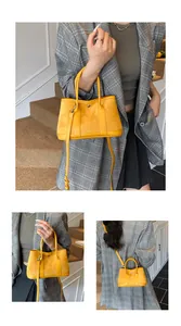 Close-up of bright yellow contrast tote bag with double handles and adjustable strap