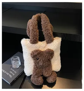 Close-up of a cozy cream faux shearling tote bag featuring a 3D plush bear and brown handles