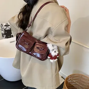 Retro deep wine red leather shoulder bag with bow details and plush puppy charm
