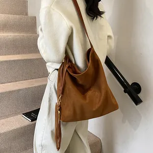 Minimalist large brown suede hobo bag for women with a vintage shoulder strap design