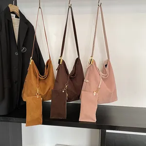 Three large suede hobo bags in brown, coffee, and pink with matching coin purses