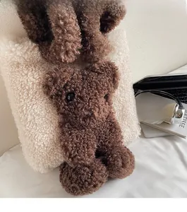 Detail of cute cream fleece tote bag featuring a 3D brown plush bear and soft strap