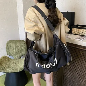 Large black Oxford fabric travel bag with white letters for fitness and short trips