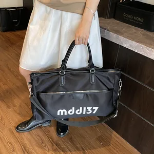 Large black Oxford travel tote with mddl37 lettering and adjustable shoulder strap