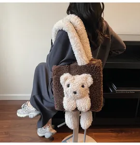 Detailed close-up of brown faux shearling tote bag with 3D cute teddy bear ornament