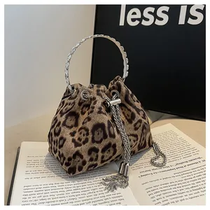 Detail of leopard print bucket bag with silver metal handle and chain tassels