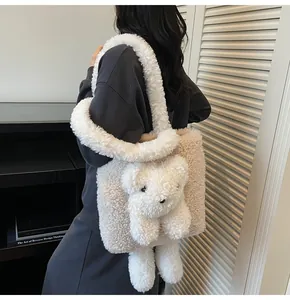 Detail of plush bear tote bag with soft cream fleece straps and beige patchwork