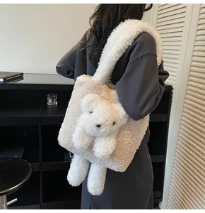 Detailed close-up of fluffy cream lamb wool tote bag with cute plush bear ornament