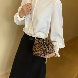 Vintage leopard print bucket bag with silver ring handle and chain strap on model