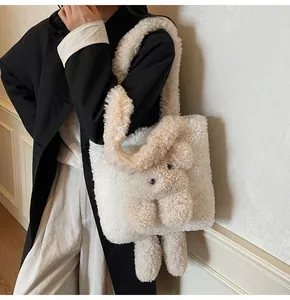 Close-up of white fuzzy sherpa tote bag featuring a cute 3D teddy bear decorative patch