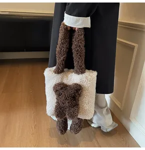 Detail of soft fleece tote bag with a cute 3D brown teddy bear and plush handles