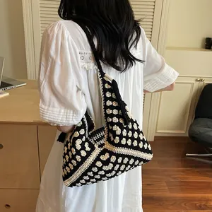 Handmade woven tote bag with black and white geometric patterns for summer beach travel