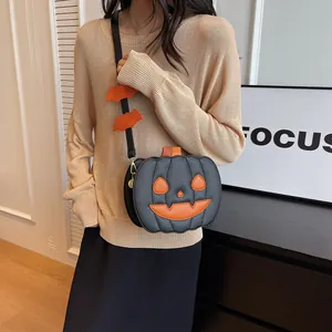 Crossbody pumpkin bag in black leather with orange face and bat strap decorations