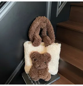 Detail of plush white fleece tote bag featuring 3D brown teddy bear and textured handle