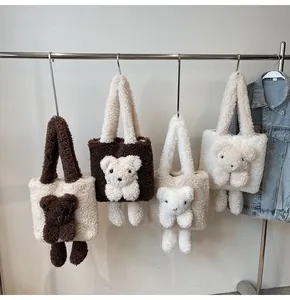 Detail of four fuzzy plush tote bags with 3D teddy bear charms in various colors
