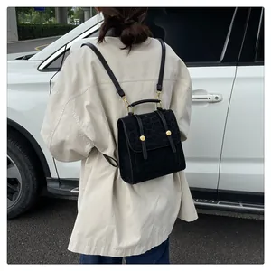 Detail eines Mini-Rucksacks in Schwarz mit Leopardenmuster und goldenen Schnallen am Rücken