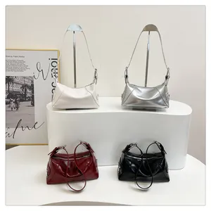 Macro detail of glossy textured handbags in multiple colors with metallic zip and buckles