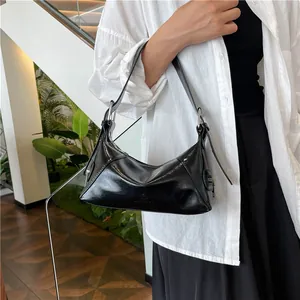 Glossy black underarm shoulder bag for women with adjustable strap and metallic buckle
