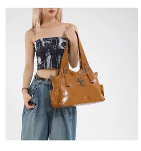Dettaglio della borsa tote vintage in pelle PU marrone con ciondolo a croce e tasche laterali