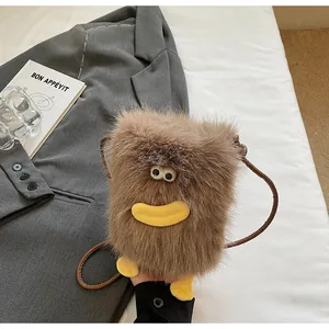 Gros plan sur un sac bandoulière en peluche marron avec visage de dessin animé