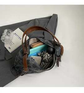 Detail view of the spacious interior of this tote bag showing laptop and daily essentials