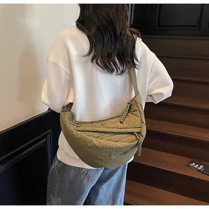 Detail view of olive green crescent crossbody bag with adjustable wide shoulder strap