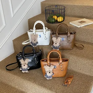 Four colors of textured bucket bags with cute charms and detachable shoulder straps