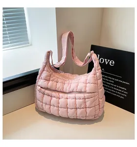 Macro detail of pink quilted puffer bag with fluffy cloud texture and adjustable strap