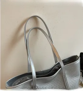 Detail view of woven texture silver tote bag with reinforced handles and secure zip closure