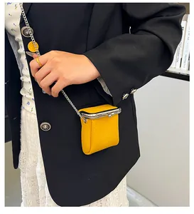 Chic yellow lychee leather mini lipstick bag with silver chain and metal frame closure