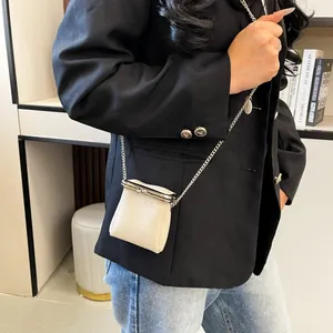 Mini off-white lychee texture lipstick pouch with silver metal chain on black blazer