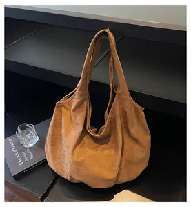Detail view of large brown suede tote bag with soft texture for casual office use
